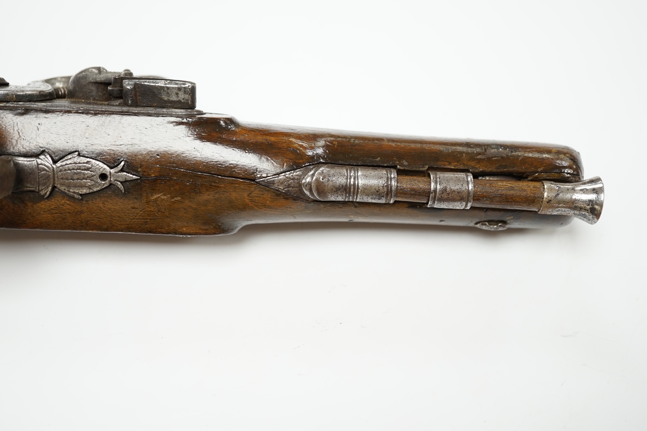 An early 19th century 12 bore fully stocked flintlock holster pistol, octagonal barrel with Birmingham proof marks, engraved iron trigger guard, iron tipped wooden ramrod, barrel 15.5cm. Condition - fair, cock replaced,